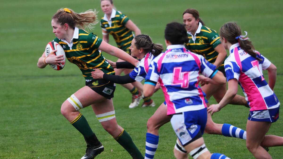 ON THE CHARGE: Liz Young breaks out of a tackle on her way to one of her three tries in Ag College's win over Wagga City on Saturday. Picture: Emma Hillier