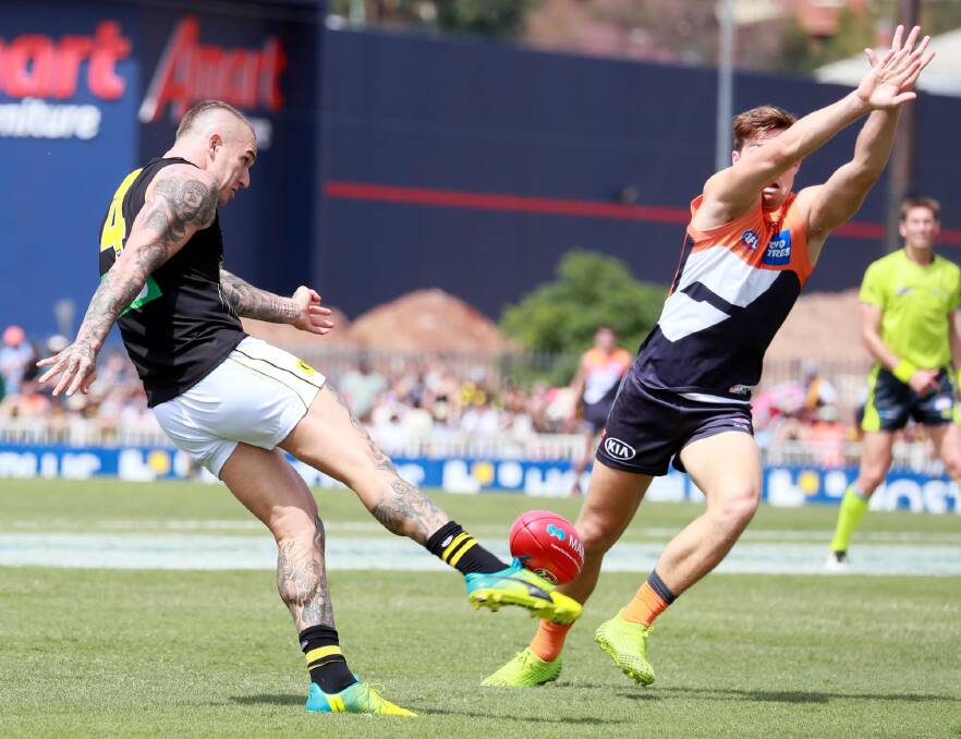 INFLUENCE: Dustin Martin gets a kick away under pressure at Robertson Oval on Sunday.