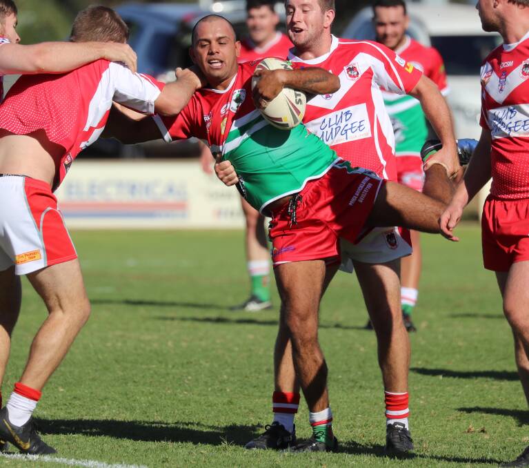 CAUGHT: Harold Kirby is wrapped by the Mudgee defence in Brothers' win in the West Wyalong Knockout quarter-final. They went on to lose the grand final to Goulburn in extra time. Picture: Les Smith