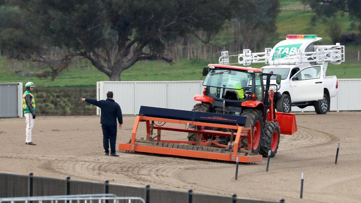 CALLED OFF: Officials and participants inspect a problem with the Riverina Paceway track on Friday which led to the last two races being abandoned. Picture: Les Smith