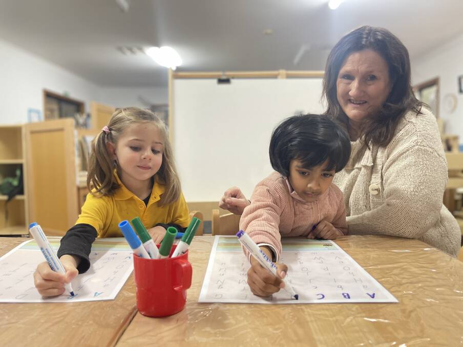 DEVELOPING SKILLS: Indi, 4, and Sai, 5, with Forest Hill Community Preschool educator Jenny Osbourne. Picture: Taylor Dodge