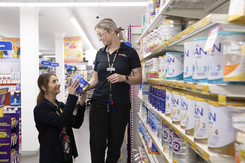 STOCKING UP: Pharmacy assistants Jehan Khodedah and Mia Seal stocking up the baby formula at Wagga's Cincotta Pharmacy. Picture: Madeline Begley 