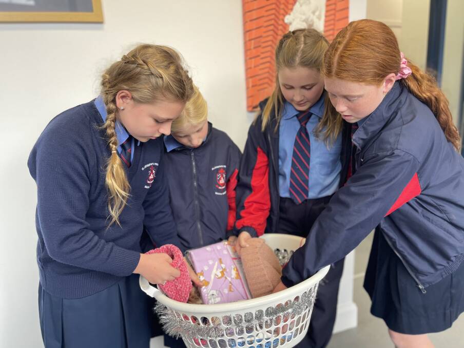 APPEAL: St Joseph's Primary School Wagga year five students Charli Hall, Violet Paton, Sienna Heffernan and Beth Ingle looking through donations. Picture: Taylor Dodge
