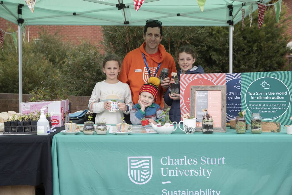 TIME TO SHINE: Manager of Sustainability Ed Maher at his CSU open day stall with children Alani (8), Kaden (5) and Tahlia (10). Picture: Madeline Begley 