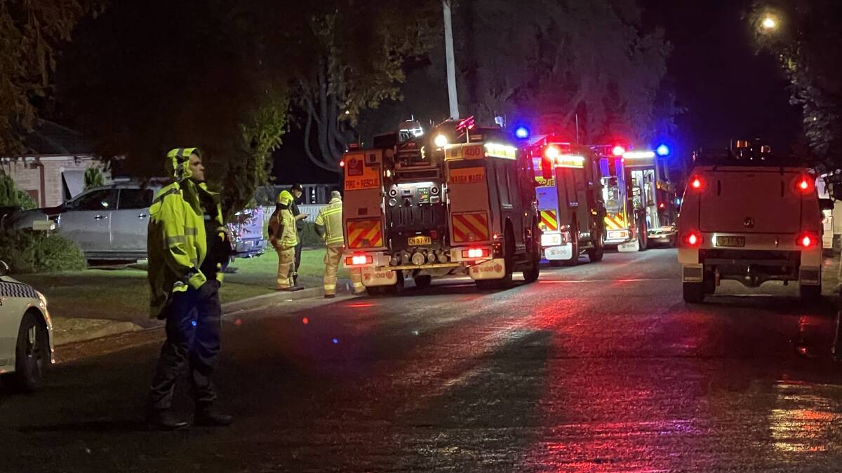 Paramedics providing first aid after victim escapes house fire