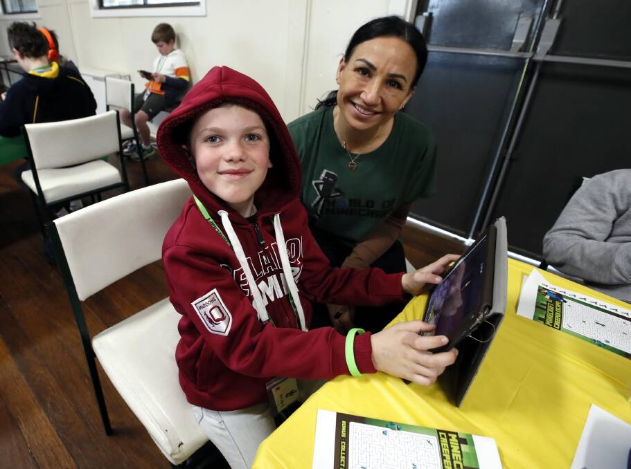 GAME TIME: Jameson Scriven, 8, with Minecraft mentor Noelene Callaghan at the Lake Albert Hall. Picture: Les Smith
