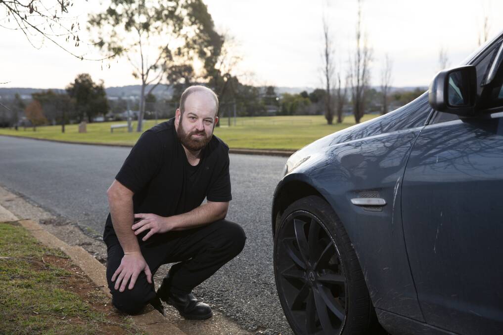 POTHOLES A PROBLEM: Wagga resident Zachary Wales remains undriveable after he hit a pothole on a city road. Picture: Madeline Begley 