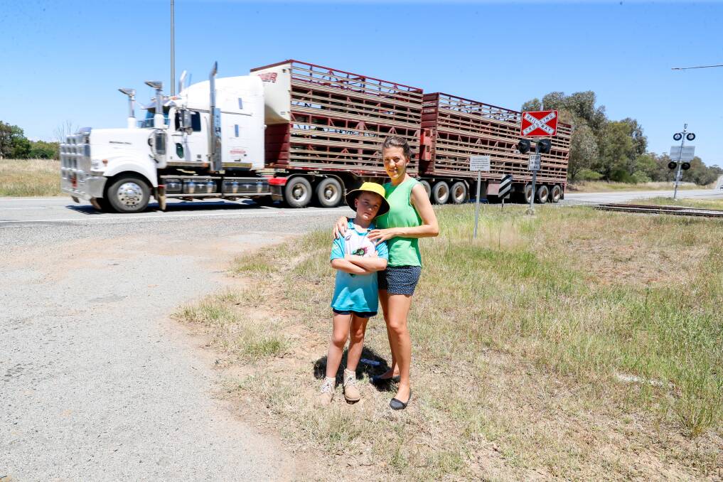 Old Junee residents Anna Lashbrook and son Henry Lashbrook, 8, are eager to see upgrades to the Goldfields Way level crossing. Picture by Les Smith 