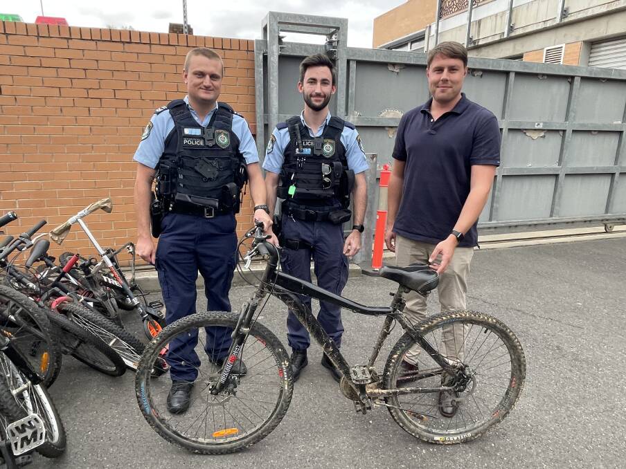 Riverina Police District Senior Constable Roffey and Probationary Constable Schiller helped Bike Canteen president Thomas Lemerle to load 38 bikes onto his ute. Picture by Taylor Dodge