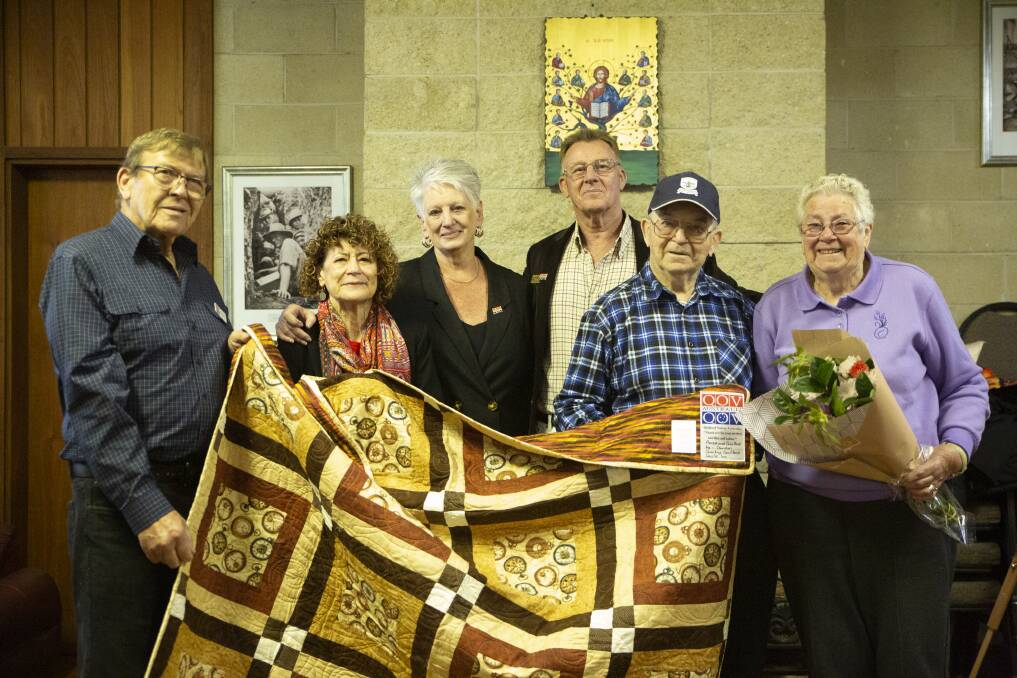 HONOUR: Wagga veteran Alan Evans (second from right), pictured with his wife Nancye (right) and (from left) Quilts of Valour state coordinators Stan and Sue Allen, Di Pilmore and Ray Smith. Picture: Madeline Begley