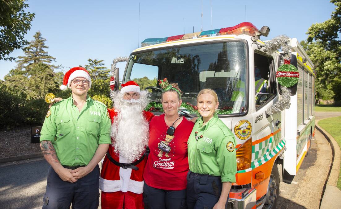 SANTA'S IN TOWN: Rescue operator Josh Jones with Santa, VRA captain Jodie Carter and rescue operator Melissa Baillie at the Botanic Gardens. Picture: Ash Smith