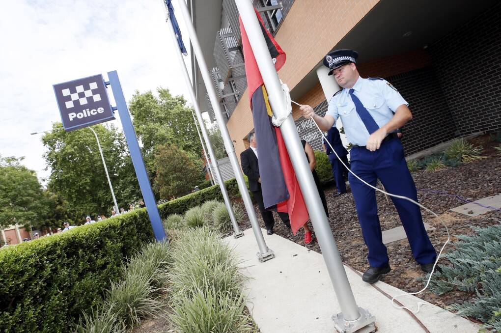RAISED: Wagga's Senior Constable Cameron Ellis was given the honour of raising the First Nations flag at Wagga Police Station's official flag-raising ceremony. Picture: Les Smith 