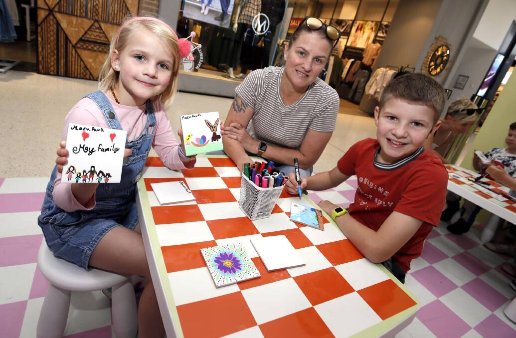GETTING CRAFTY: Wagga mum Therese Paull with her kids Maev Paull, 8, and Owen Paull, 10, at the Marketplace. Picture: Les Smith