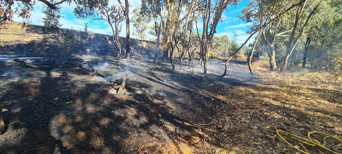 RISKS REMAIN: NSW RFS and Fire and Rescue NSW crews put out a fire within the Silvalite Reserve, west of Lloyd, on Thursday afternoon. Picture: Riverina RFS