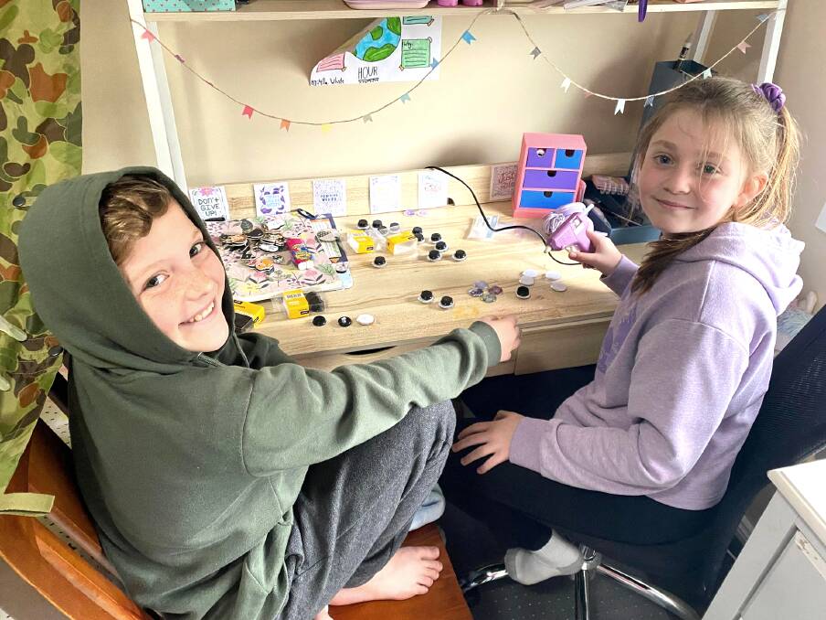 WORKING TOGETHER: Lucas and Milla in the middle of making their fridge magnets which they sold for charity. Picture: Contributed
