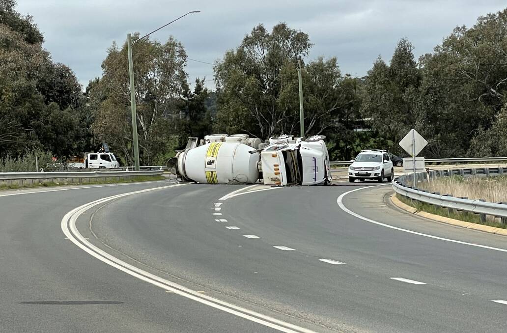 ON ITS SIDE: A cement truck that rolled at the Olympic Highway and Old Narranderah Road intersection caused disruptions to traffic at the site yesterday afternoon. Picture: Rex Martinich 