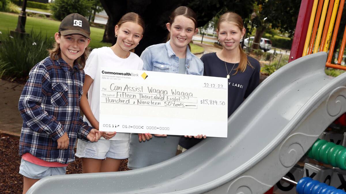 Joey Rake, 10, Lulu Rynehart, 12, Ellie Rake, 12, and Indi Rynehart, 14, with a check from Wagga Can Assist. Picture by Les Smith 