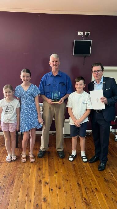 Recognition: John Neyland with Dr Joe are Mr Neylands grandchildren, Aubrey, Alayna and Chace Neyland. Picture: Contributed 