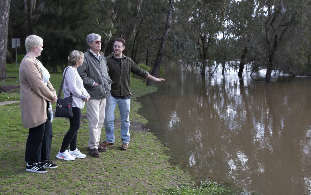 LOOKING: Wagga's Kate Allman with Jean and Steven Allman and James Farley at the swollen river at Wagga Beach. Picture: Madeline Begley 