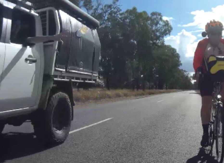 The moment a bottle was thrown at a group of cyclists from a passing ute on Old Narrandera Road near Gobbagombalin on April 7. Picture supplied 
