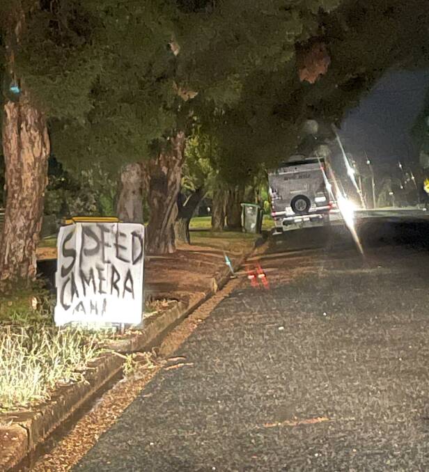 SIGN OF THE TIMES: Ashmont resident sets up a makeshift speed camera ahead sign to warn motorists of a parked mobile speed unit. Picture: Taylor Dodge