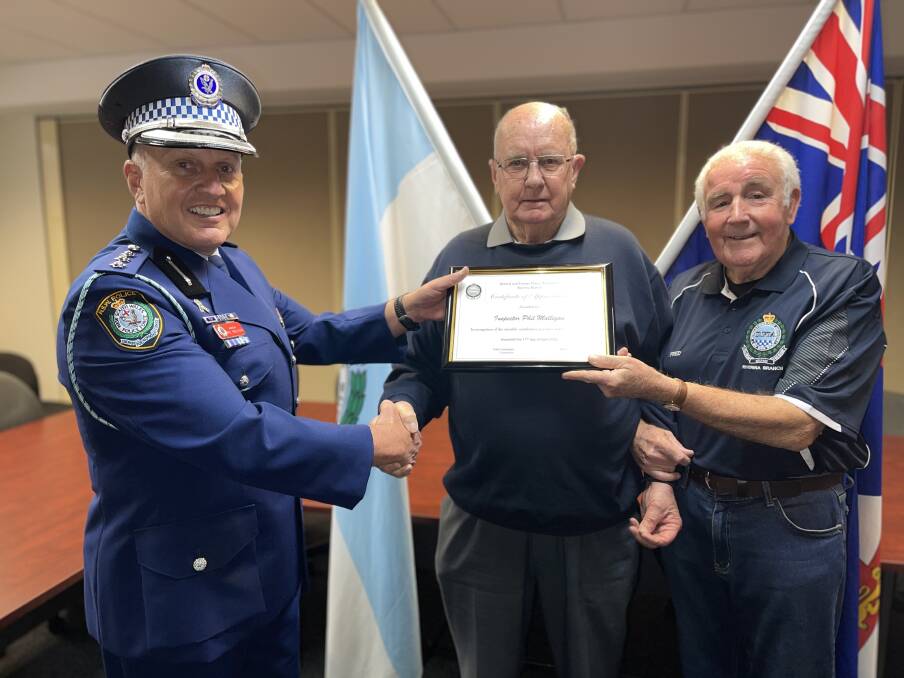 AWARDED: Inspector Phil Malligan accepts his award from retired officers Kevin Barber and Fred Loneragan. Picture: Taylor Dodge