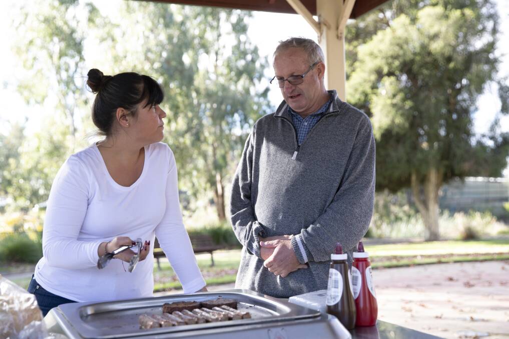 Peer group coordinator Yvonne Lingua speaking with Len Robinson at a barbeque hosted by Regional Disability Advocacy Service. Picture: Madeline Begley