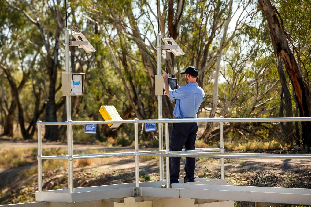 A NRAR officer inspecting a meter. Picture supplied