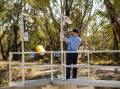 A NRAR officer inspecting a meter. Picture supplied