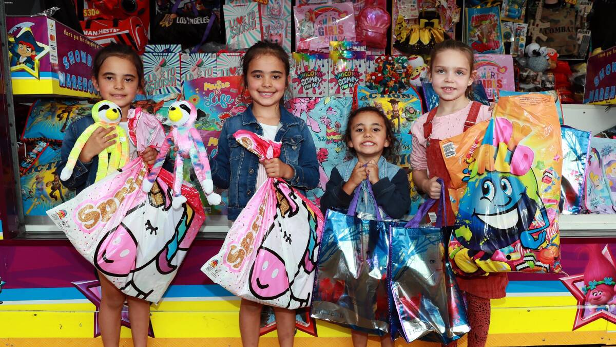 FUN DAY OUT: Airlee-Jayne O'Neill and Alexys O'Neill with their sister Anaiah, and Charlette Nix are pleased with their showbag spoils from the carnival. Picture: Les Smith 