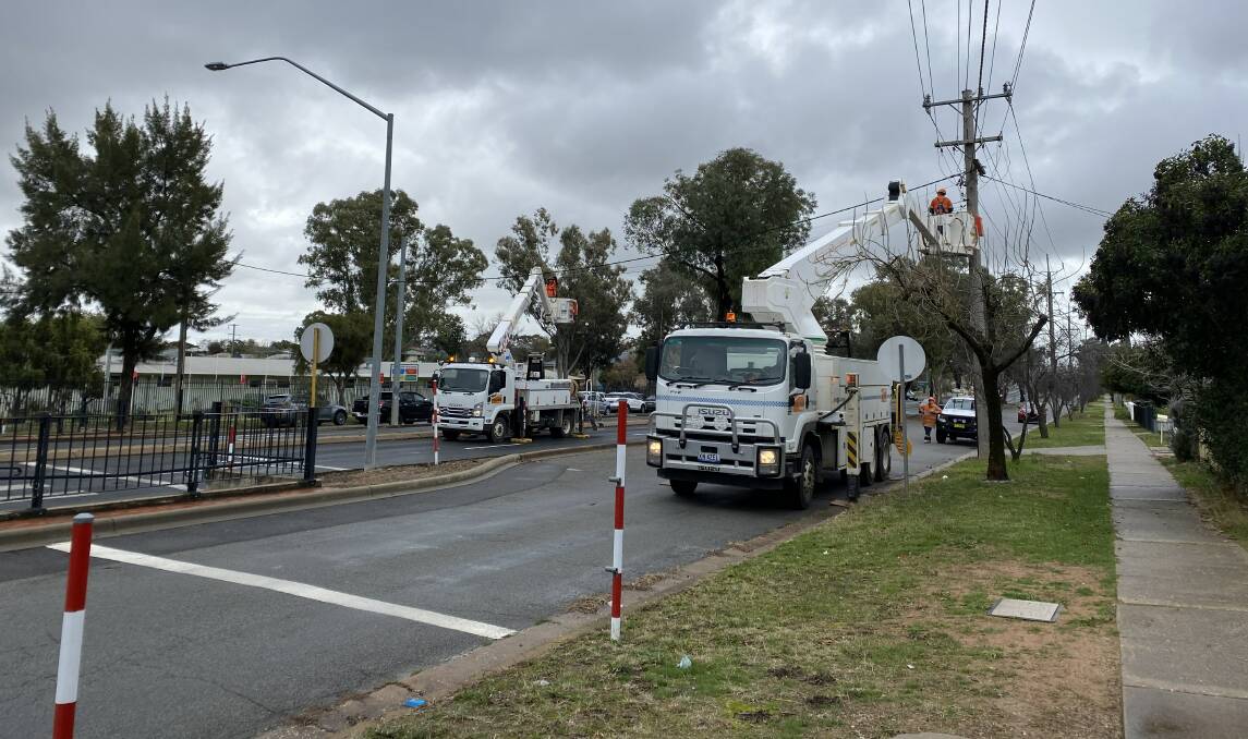 NEW SIGHT: Essential Energy workers replace lights on Bourke Street near the school crossing on June 25. Picture: Andrew Pearson