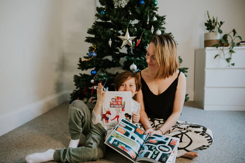 STORY TIME: Sarah-Jane Edis with her son Hadley, 6, reading Mrs Clause does the Uthinkable!, a book that started on a family road trip in 2019. Picture: Supplied 
