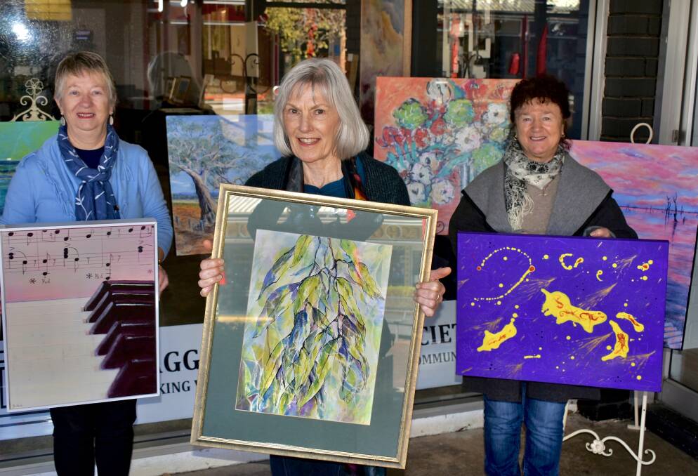 BRIGHT DISPLAY: Gwen Bullock, Marion Addinsall and Catherine Kindleysides from the Wagga Art Society all have art on display at the Kooringal shop. Picture: Catie McLeod 