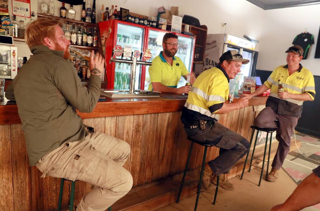 The Batlow Hotel still had the beer flowing, thanks to a petrol powered generator and enjoyed by Trent Harvey, publican Matt Rudd, Jake Smith and Matt Flenley.