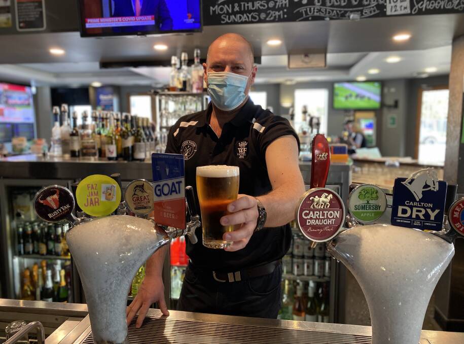 CHEERS TO ROLLING UP YOUR SLEEVE: Mick Carroll, the new manager at the William Farrer Hotel, received his shot on Friday morning (when this photo was taken). Picture: Annie Lewis 
