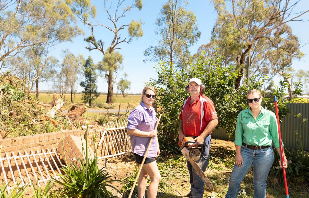 Amy Baker, Paul Baker and Hannah Baker start to clear up at Mangoplah. Picture: Ash Smith 
