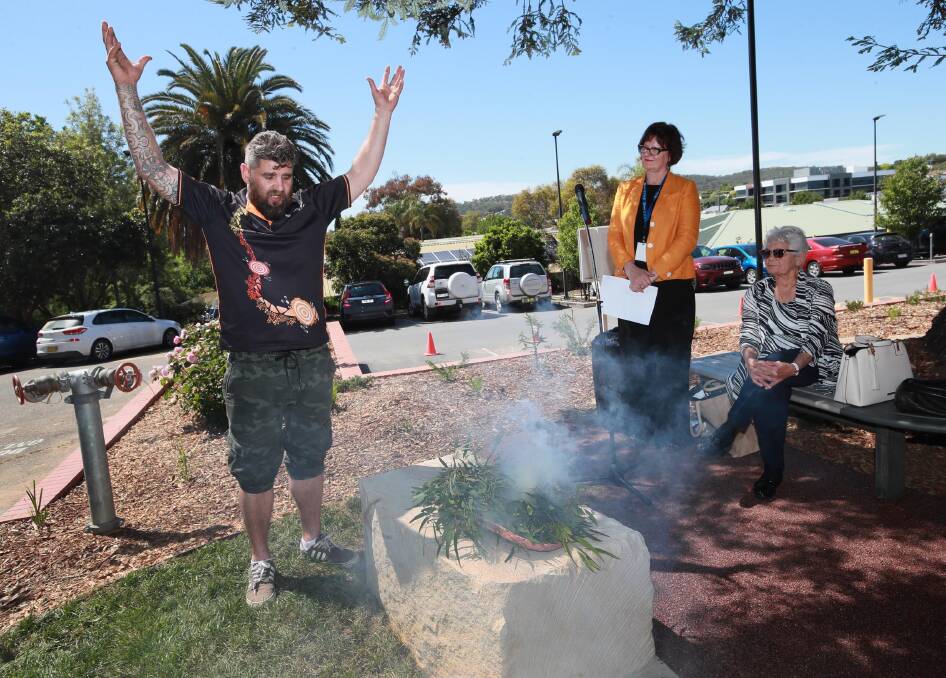 CLEANSING: Peter Ingram conducts the Smoking Ceremony as Robin Haberecht and Wiradjuri elder Aunty Isabel Reid watch on. Picture: Les Smith 