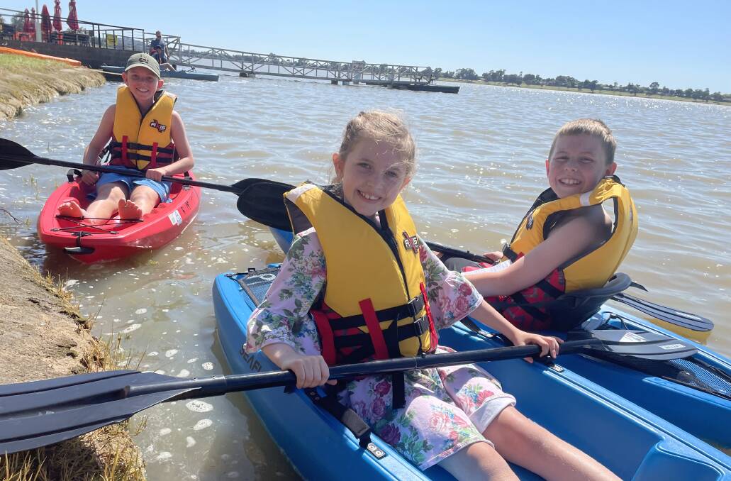 ALL SMILES: Henry Bolton, 11, Claudia Bolton, 7, and Gus Bolton, 9, enjoy a sunny day ok kayaking on Lake Albert. Picture: Annie Lewis