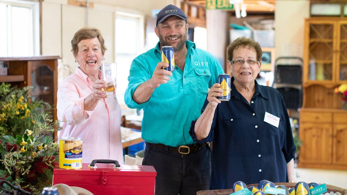 CHEERS TO THAT: Marlene Pearce, Scott Barrett, and Andrea Quinn as the Men's Shed welcomes 'beer money' from GIVIT. Picture: Supplied 