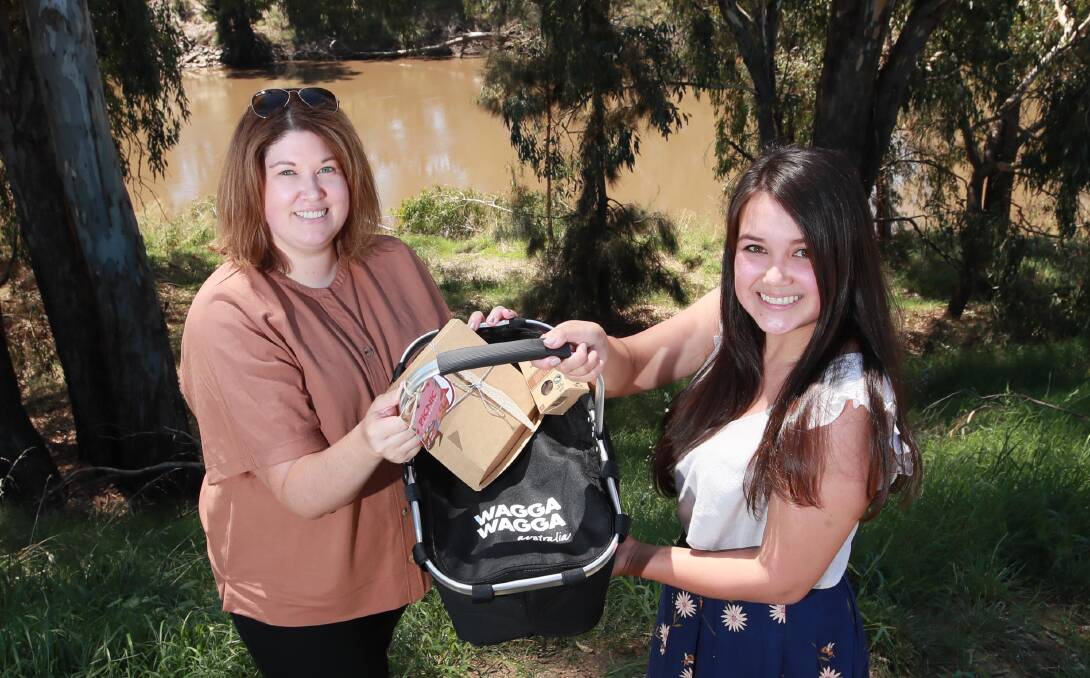 PERFECT WEATHER: Stacey Post and Kim Parker from Wagga City Council's Events and Visitor Economy encourage residents to purchase their tickets and take part in the picnic trail. Picture: Les Smith 