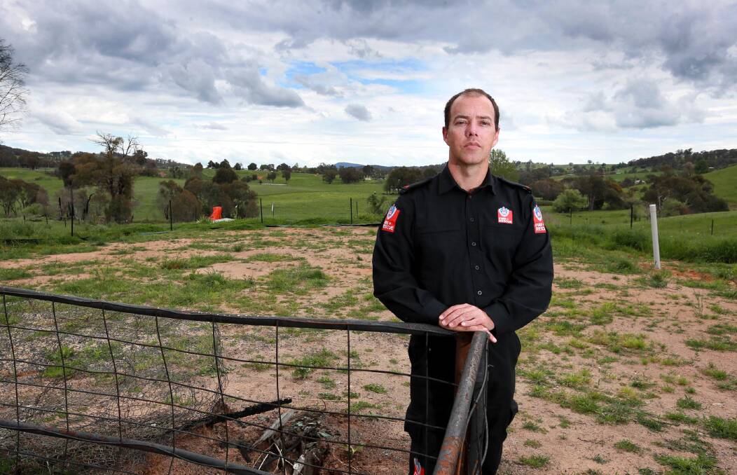 RAVAGED LANDS: Michael Pratt stands in front of the property where his home used to be. He was out fighting the fires when the blaze overran the house. Picture: Les Smith 