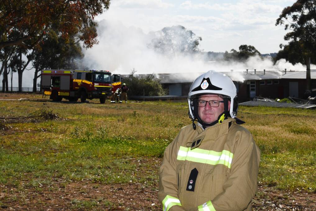 MESSAGE TO COMMUNITY: Stewart Alexander at a structure fire on the old Charles Sturt campus in 2019. 