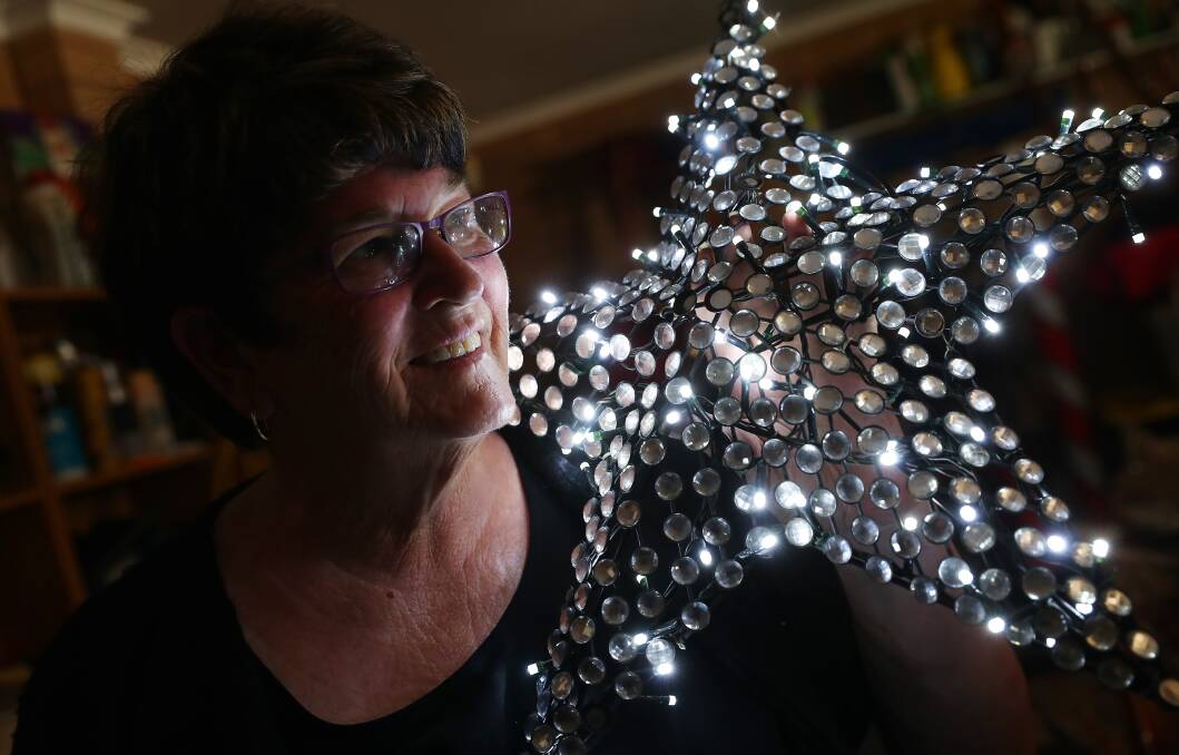 LIGHT IT UP: Shirley O'Brien, alongside her husband, goes all out every year when it comes to stringing up Christmas decorations outside their house. Picture: Emma Hillier 