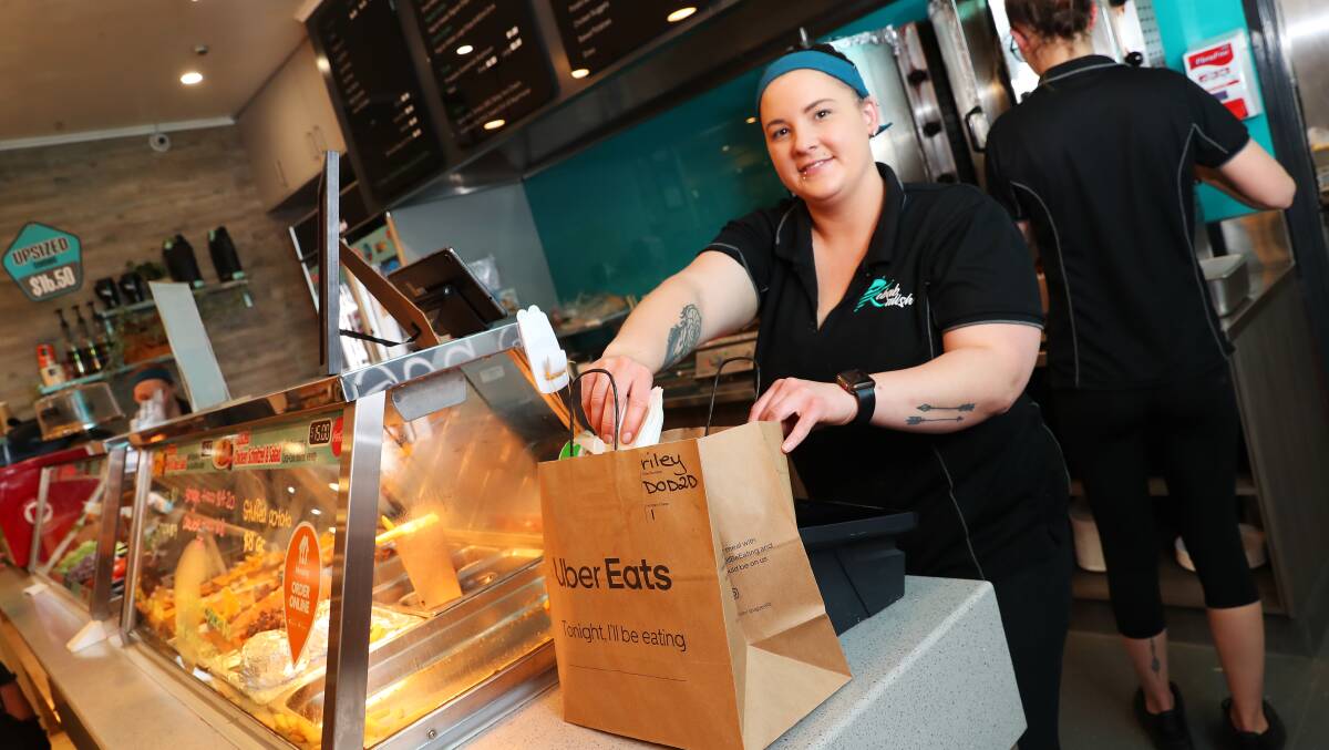 BRINGING IN CUSTOMERS: Kebab'alish employee Maddie Watts prepares an Uber Eats order to send off for delivery. Owner Mandy Patey said despite issues with drivers, she is pleased to have the service. Picture: Emma Hillier 