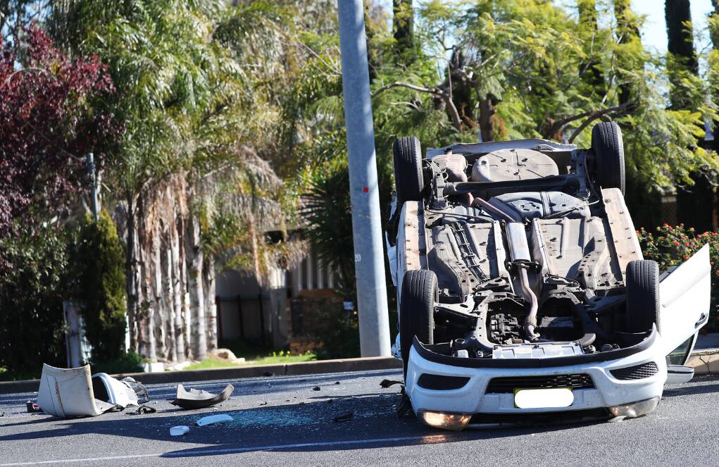 CRASH SCENE: A woman was taken to hospital with head injuries after a car flipped on Bourke Street at Mount Austin in June 2020. Picture: Emma Hillier 