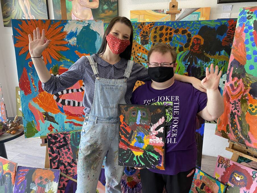COLOURFUL ADVENTURES: Hayden Watts, with his teacher Tahlia Keogh, is preparing for his upcoming "spooktacular" exhibition inspired by horror films and Halloween. 