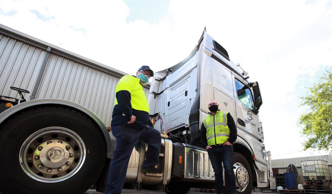 ON THE ROAD: Interstate truck driver Terry Williams with Ron Crouch Transport site operations manager Ryan Barry. Picture: Les Smith