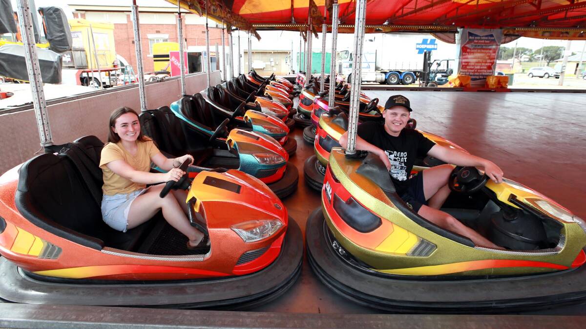 READY FOR THE WEEKEND: Caitlin Johnson and Roy Bell test out the dodgem cars ahead of the Spring Carnival opening. Picture: Les Smith