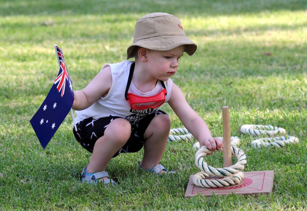 DAY OUT: Two-year-old Reuben Paget keeps himself entertained at the Australia Day celebrations at the Victory Memorial Gardens.