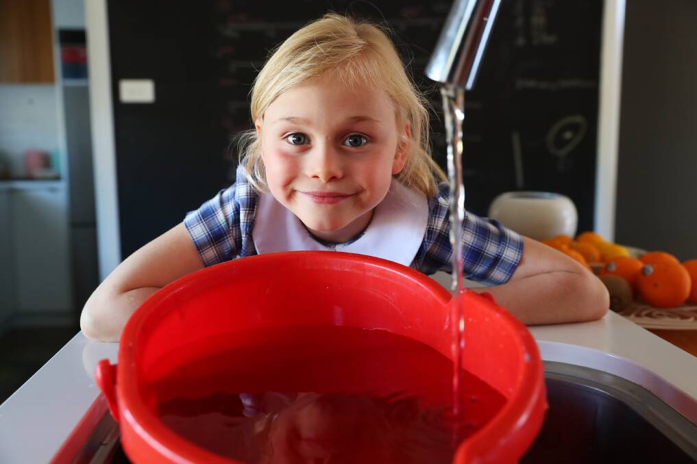 WATER WISE: Matilda Viski, 7, filling up her bucket in preparation for the first-ever, 12-hour water night challenge. Picture: Emma Hillier
